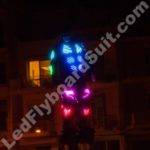 Man in LED sui is flying under the river