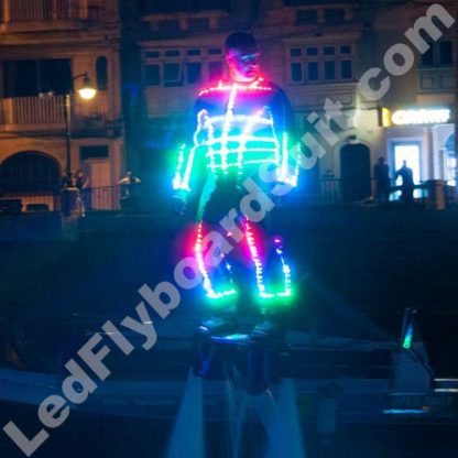 Male is flying on flyboard and his suit is glowing in different colours